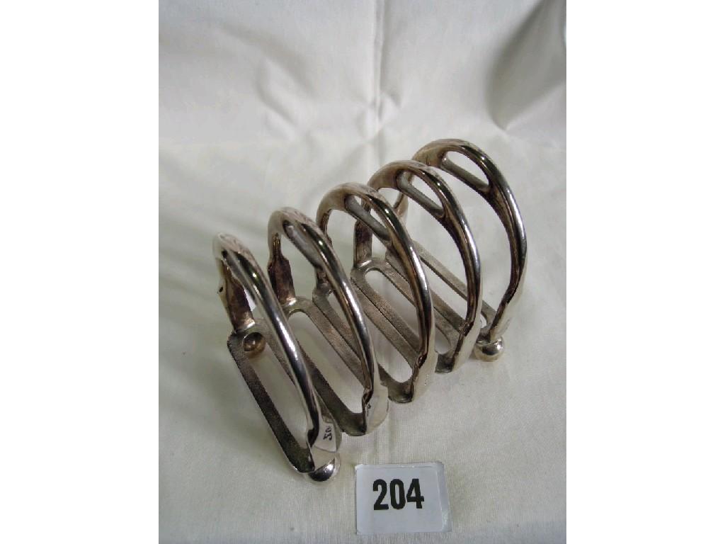 Appraisal: A silver plated toast rack in the form of stirrups