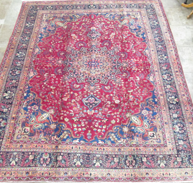 Appraisal: SEMI-ANTIQUE PERSIAN MASHAD CARPET floral and central floral medallion design