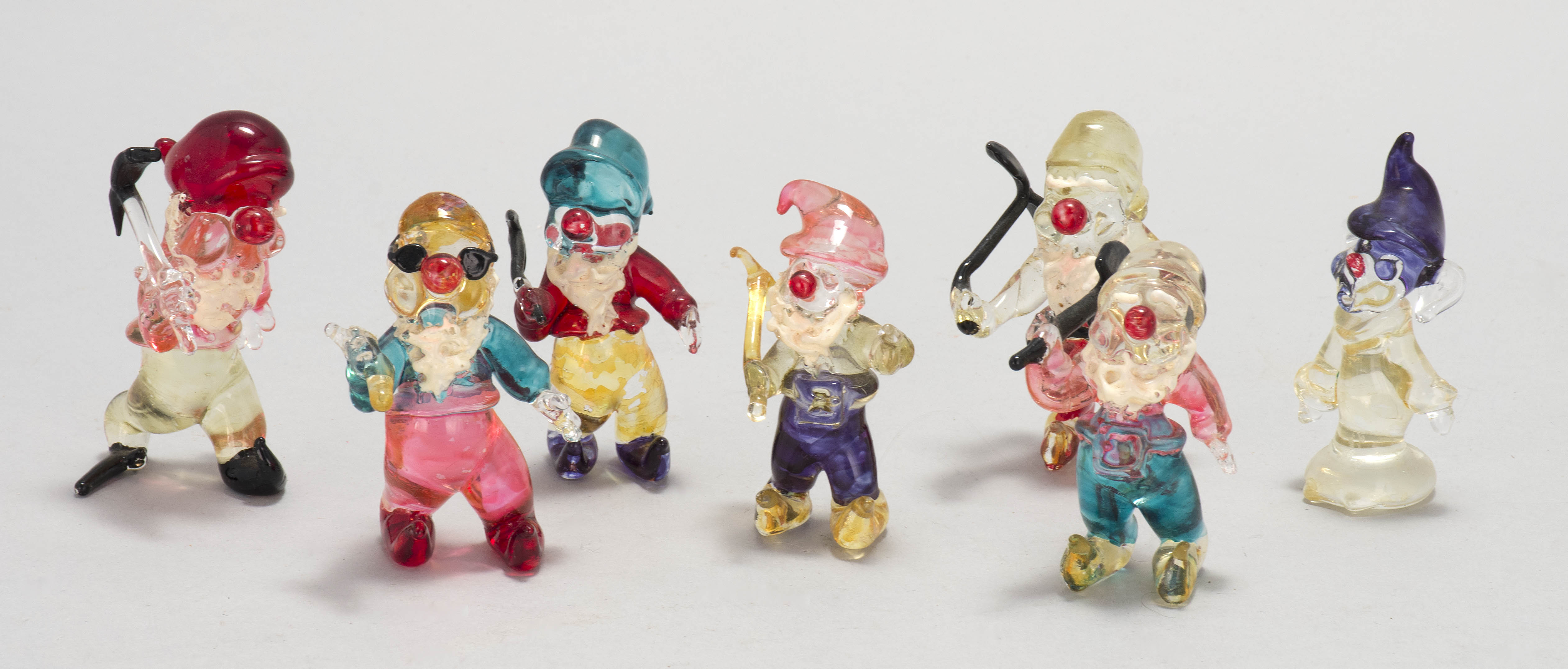 Appraisal: VENETIAN GLASS FIGURINES OF SEVEN DWARFS With colorful glazes Heights