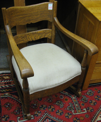 Appraisal: A ROCKING OAK ARMCHAIR American early th century having a