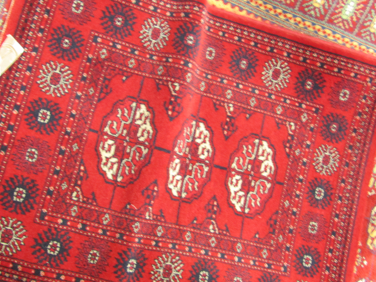 Appraisal: A Keshan rug decorated with geometric motifs against a red