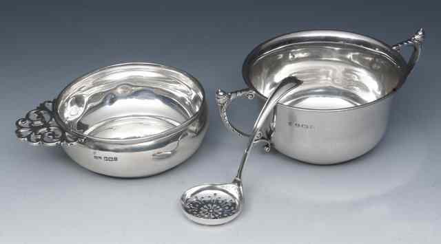 Appraisal: A GEORGE V SILVER PORRINGER with a pierced scrolled handle