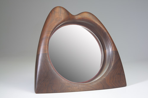 Appraisal: WENDELL CASTLE Fine stack-laminated tabletop mirror with sculptural frame and