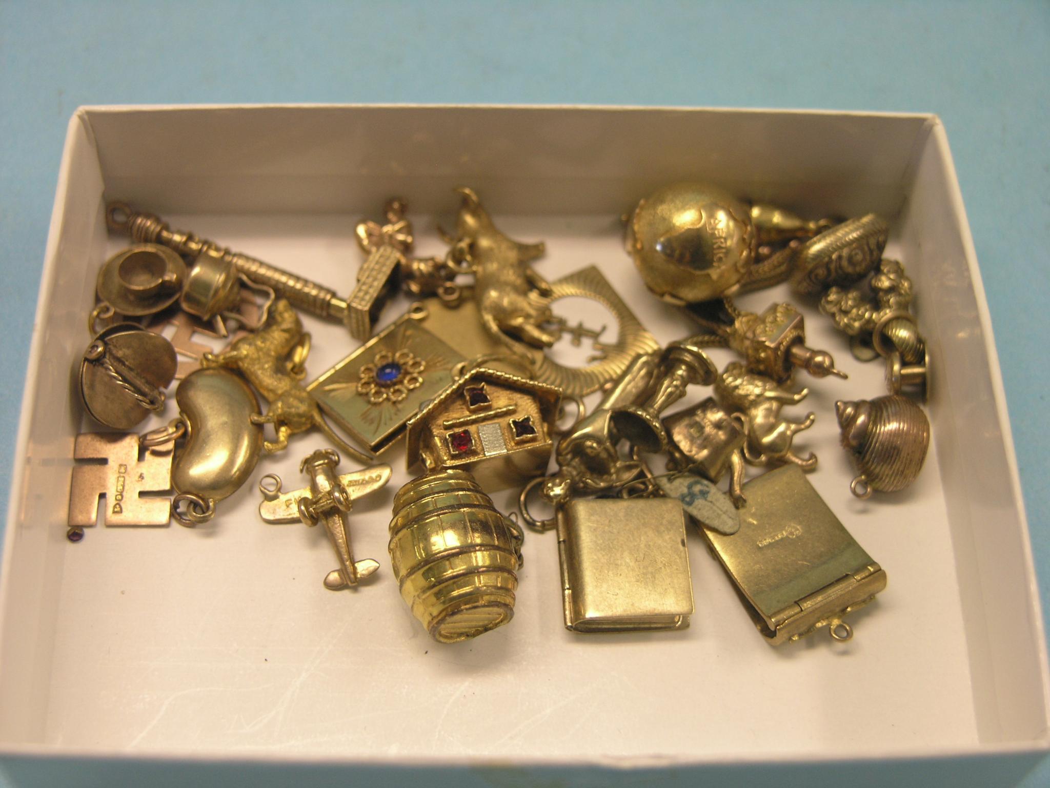 Appraisal: Twenty-four charms ct gold and yellow metal grams gross total