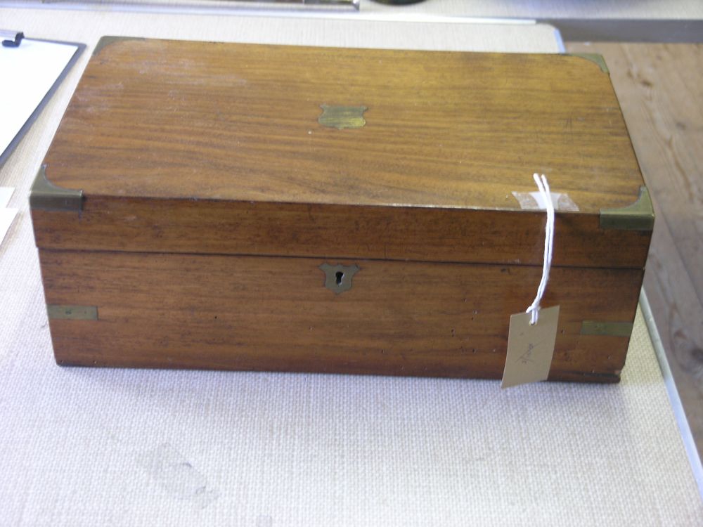 Appraisal: A Victorian walnut writing box with brass mounts enclosed slope