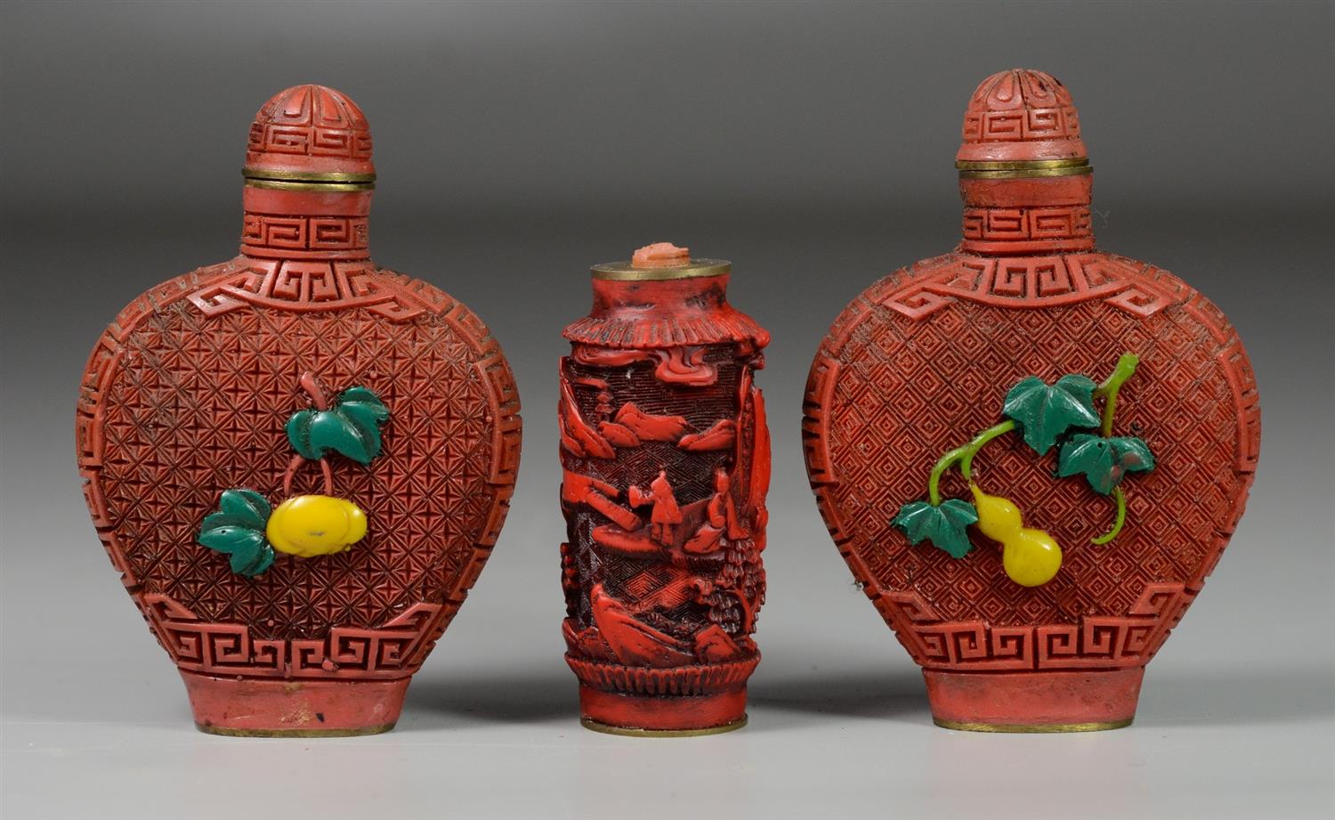 Appraisal: Chinese cinnabar snuff bottles two with fruit overlay smallest missing