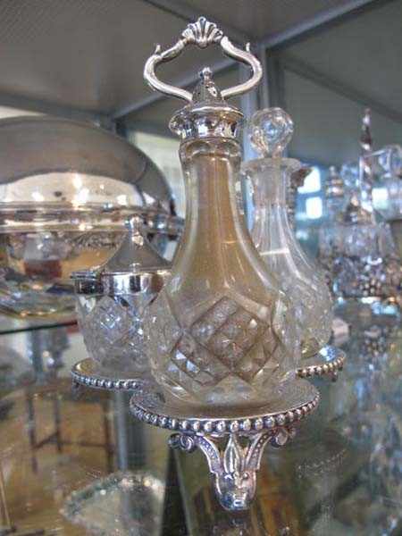 Appraisal: SILVER PLATE AND CUT GLASS THREE BOTTLE CRUET SET