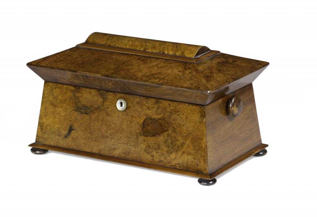 Appraisal: A VICTORIAN WALNUT TEA CADDY of sarcophagus shape the fitted