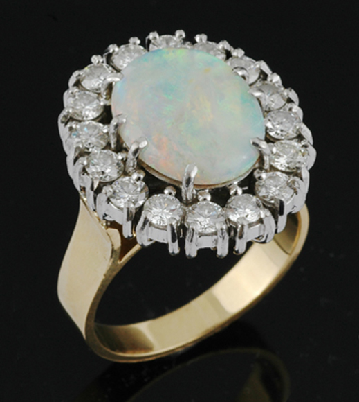 Appraisal: An opal and diamond cluster ring Centrally set with a