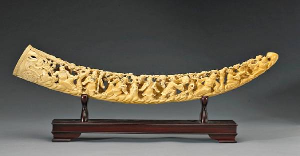 Appraisal: A tinted and reticulated ivory tusk depicting the eight Daoist