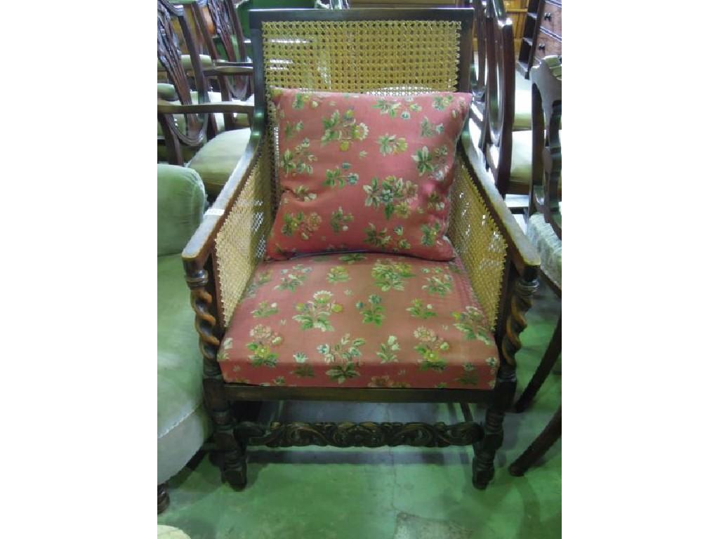 Appraisal: A 's bergere armchair with stained beechwood frame upholstered seat