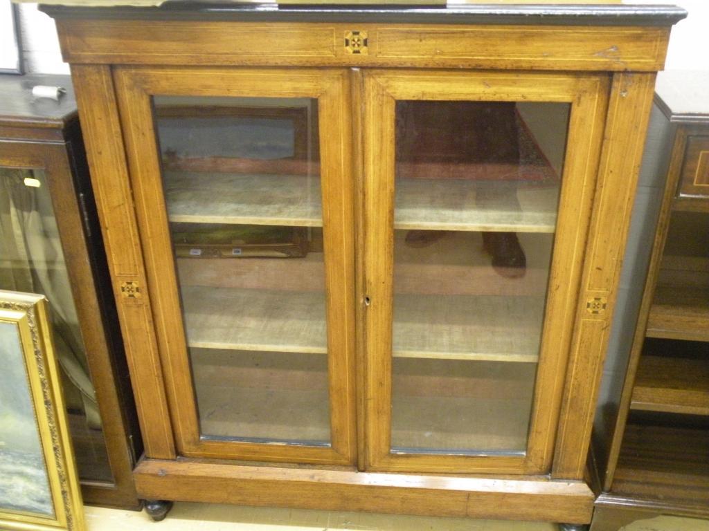 Appraisal: A Victorian walnut and marquetry pier cabinet with velvet lined