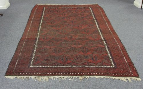 Appraisal: An Afghan rug with geometric pattern within a multiple border