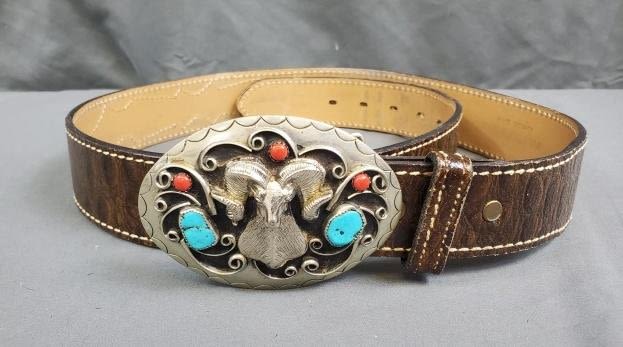 Appraisal: Vintage Brown cowhide belt with a silver tone buckle with