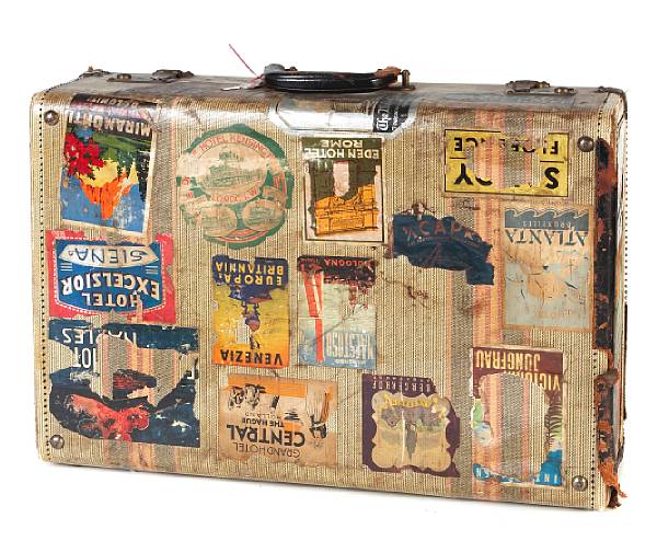 Appraisal: A vintage hard sided suitcase all-over applied with luggage labels