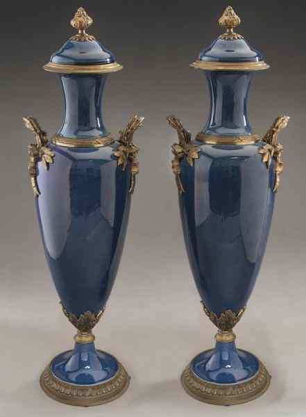 Appraisal: Pr Sevres style pottery lidded urns with giltbronze handles base