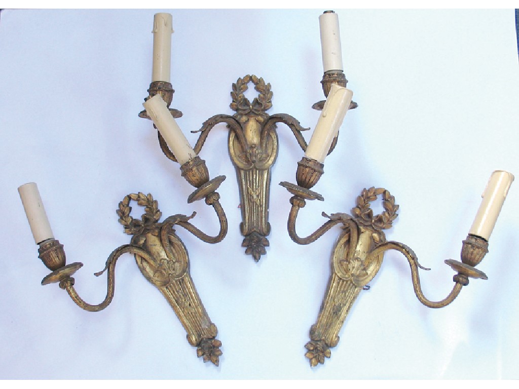 Appraisal: A SET OF THREE GILT METAL WALL LIGHTS each with