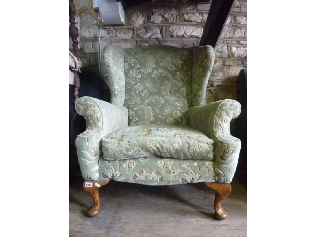 Appraisal: A Georgian style wing chair with shaped outline upholstered finish