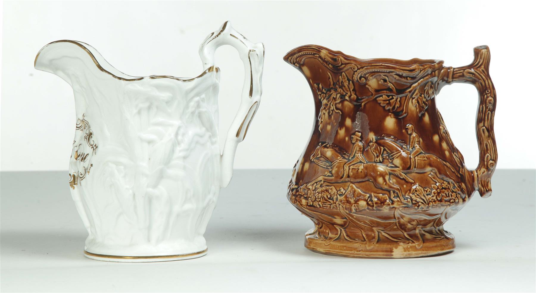 Appraisal: TWO EMBOSSED PITCHERS England rd quarter- th century Rockingham with