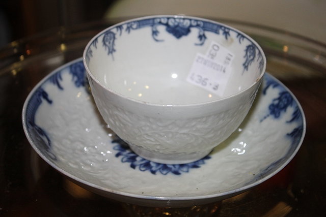 Appraisal: A FIRST PERIOD WORCESTER RELIEF MOULDED TEA BOWL and saucer