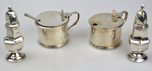 Appraisal: A pair of silver drum mustards with blue glass liners