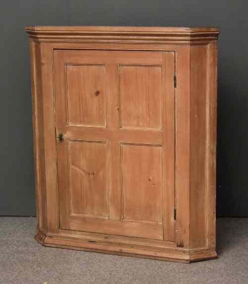 Appraisal: A late Georgian stripped pine hanging corner cupboard fitted two