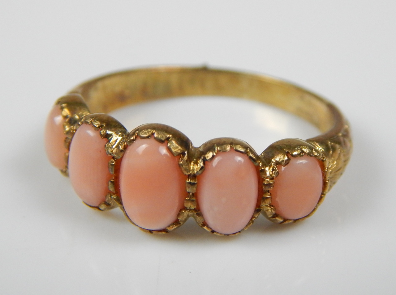 Appraisal: A modern dress ring set with five pink stones on