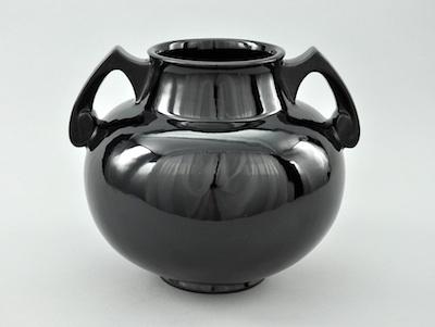 Appraisal: A Roseville Black Jardiniere An attractive black gloss footed jardiniere