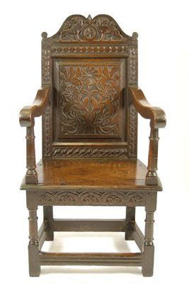 Appraisal: A joined oak armchair with a shaped crest carved a