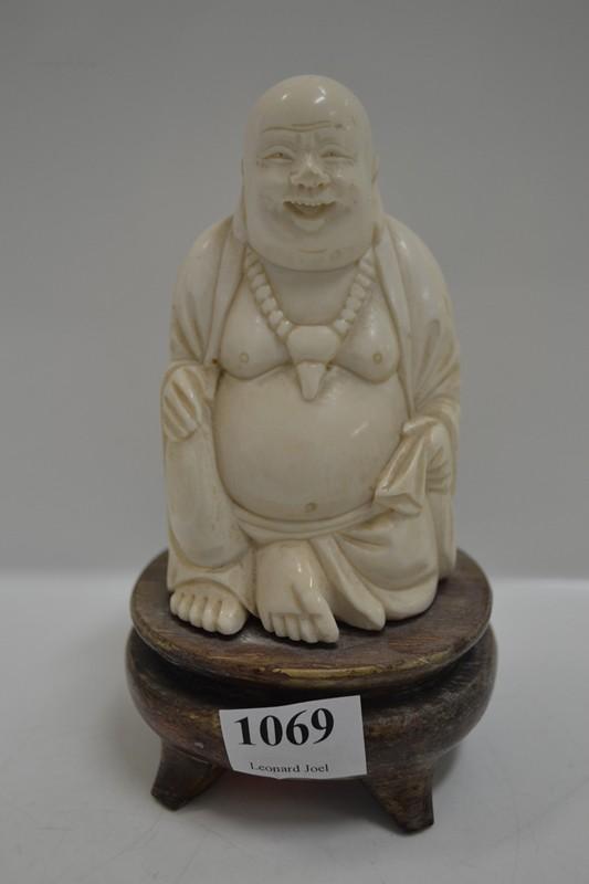 Appraisal: CARVED IVORY FIGURE OF BUDDHA ON WOODEN BASE