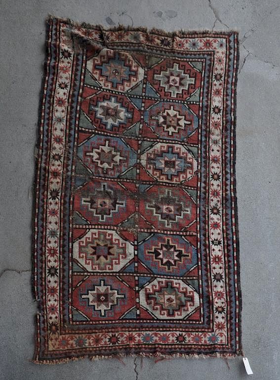 Appraisal: Caucasian Rug with use wear repairs losses holes long wide