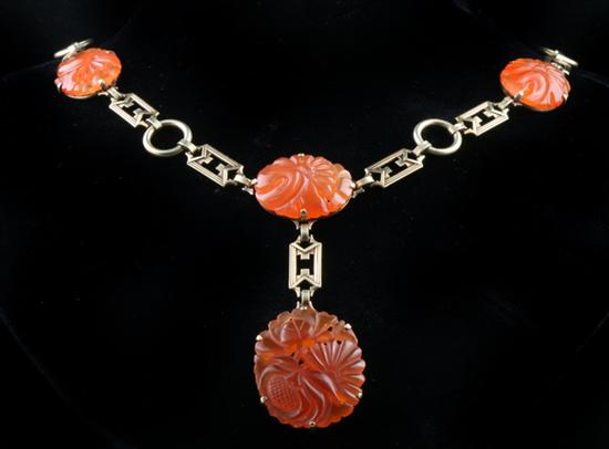 Appraisal: ART DECO K YELLOW GOLD AND CHINESE CARVED CARNELIAN FLEXIBLE-LINK