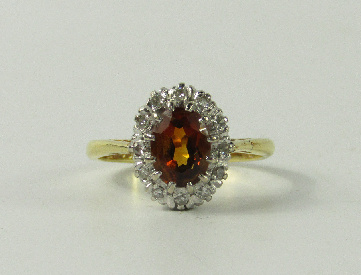 Appraisal: An ct gold orange topaz and diamond set ring the