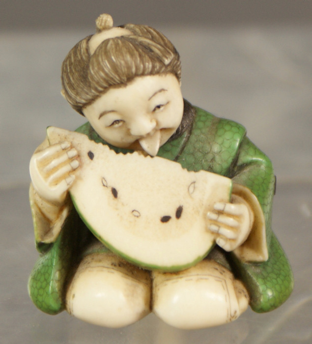 Appraisal: Netsuke Japanese ivory carving of a young woman eating watermelon