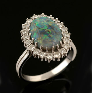 Appraisal: An opal and diamond cluster ring The semi black oval