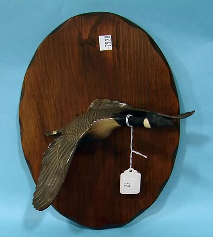 Appraisal: Flying Canada Goose metal sculpture on wood plaque