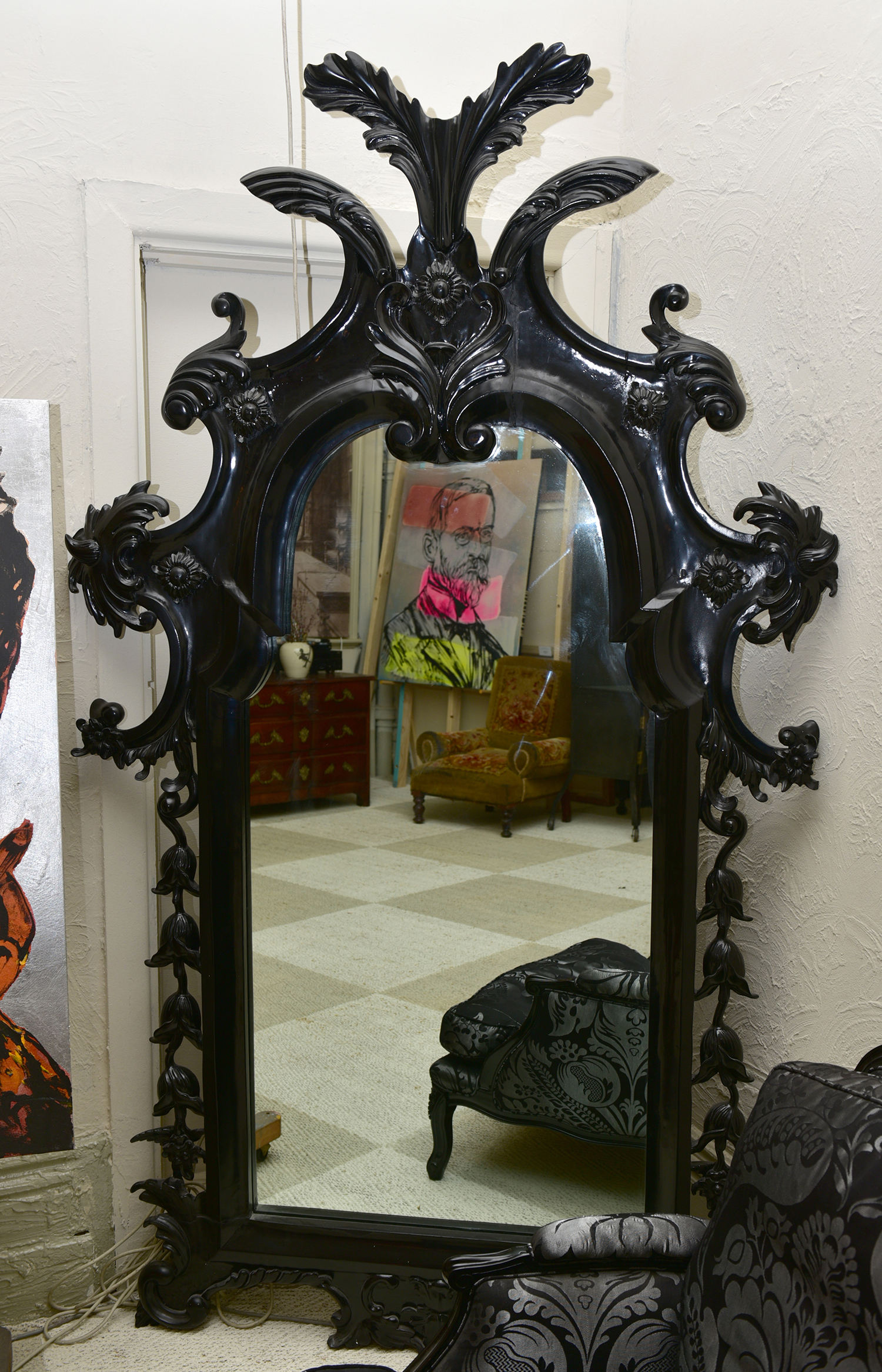 Appraisal: A CONTINENTAL STYLE BLACK PAINTED WALL MIRROR IN ORNATE MOULDED