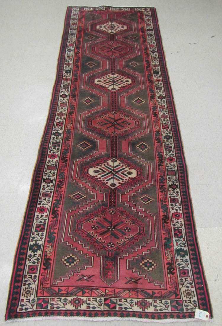 Appraisal: SEMI-ANTIQUE PERSIAN HALL RUG featuring a column of six hexagonal