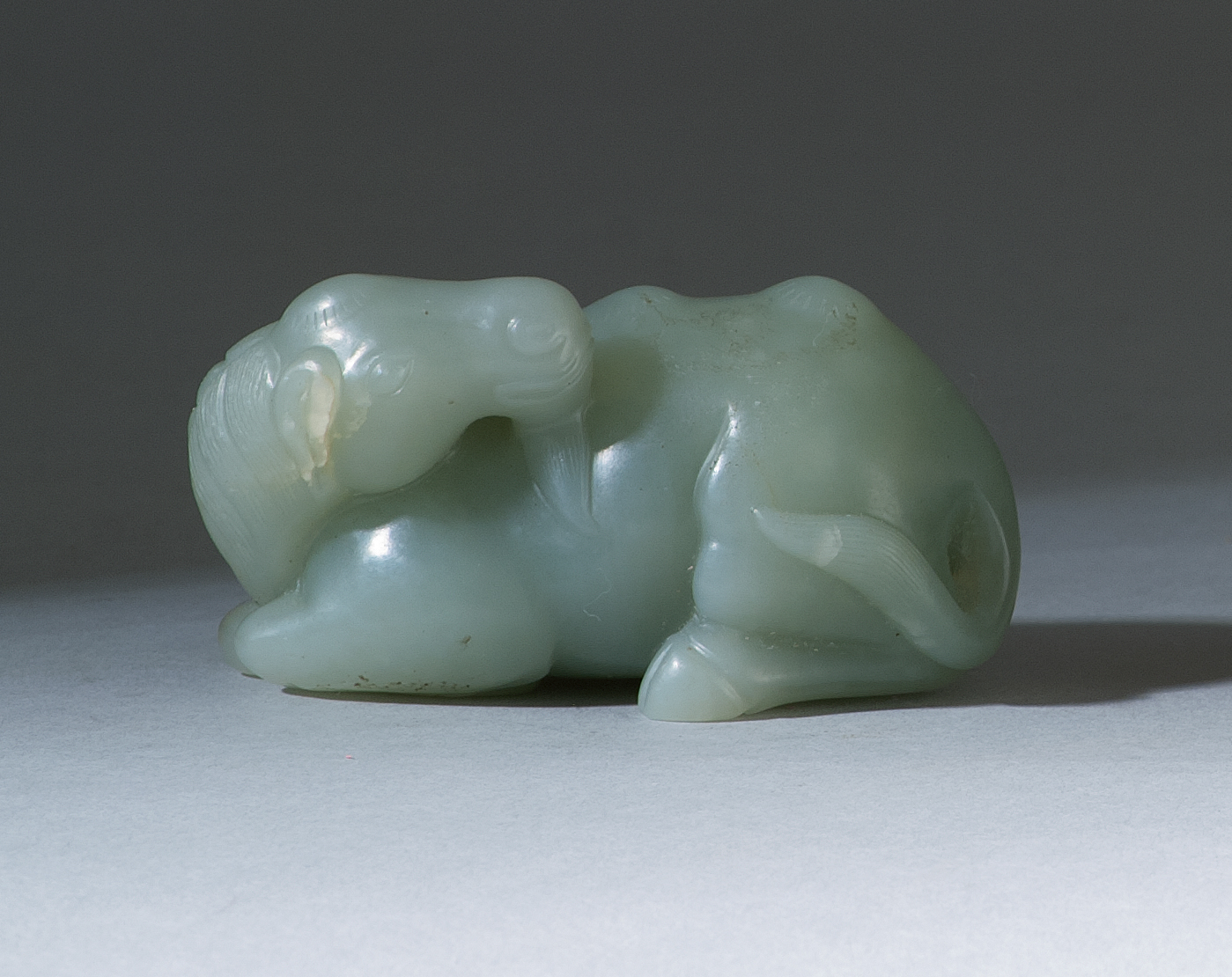 Appraisal: CELADON JADE CARVING In the form of a reclining camel