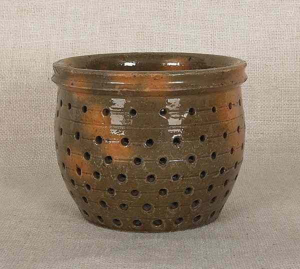 Appraisal: Pennsylvania redware colander th c with green and orange glaze