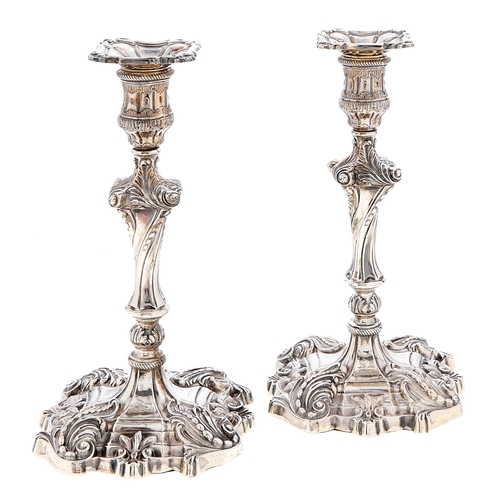 Appraisal: A pair of Victorian silver rococo revival candlesticks nozzles cm