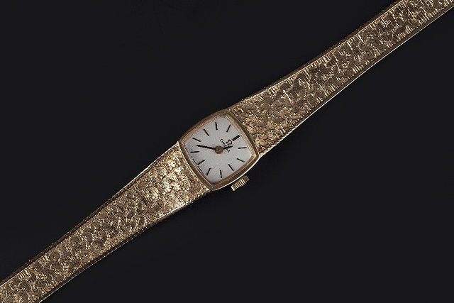 Appraisal: A LADY'S CT GOLD BRACELET WATCH BY OMEGA the cushion-shaped