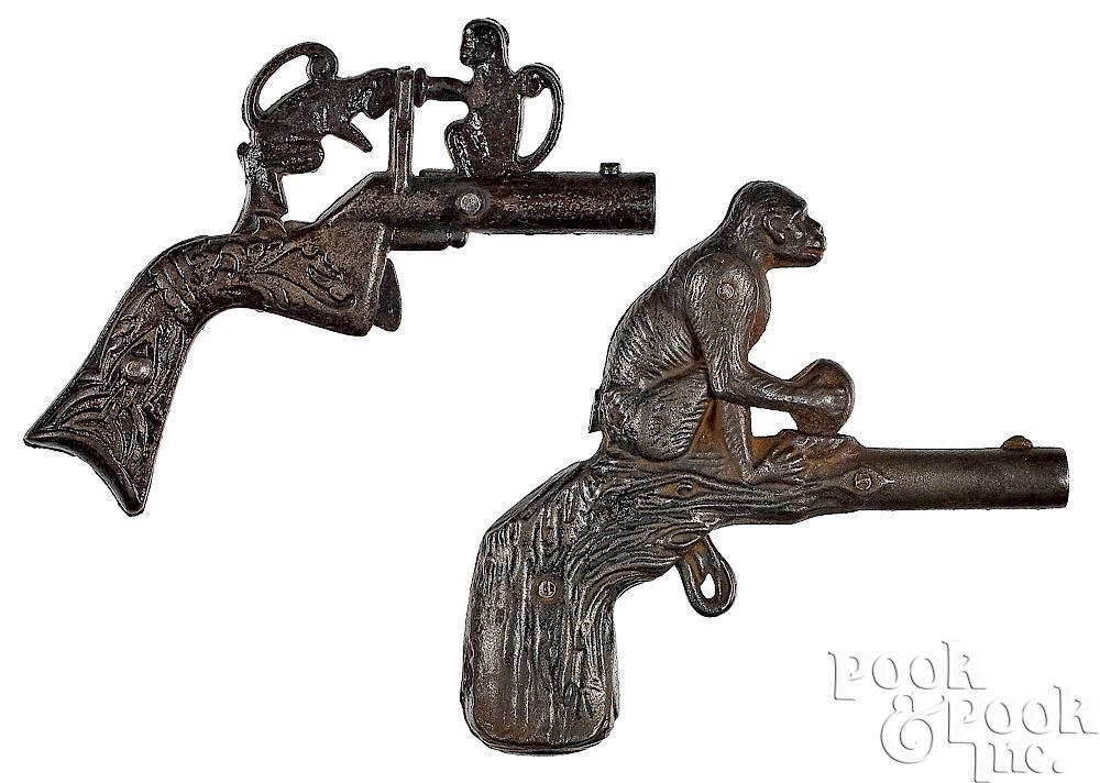 Appraisal: Two cast iron animated monkey cap guns Two cast iron