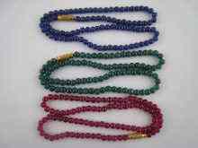 Appraisal: A ruby bead necklace a sapphire bead necklace and an