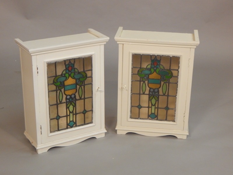 Appraisal: A pair of painted cabinets each with a stained glass