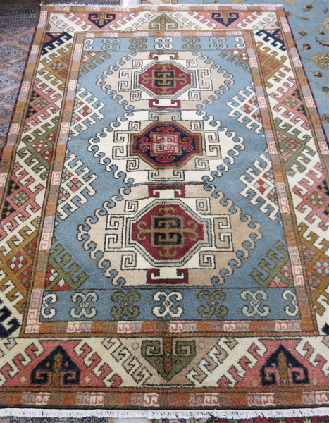 Appraisal: HAND KNOTTED ORIENTAL CARPET Indo-Kazak featuring a column of three