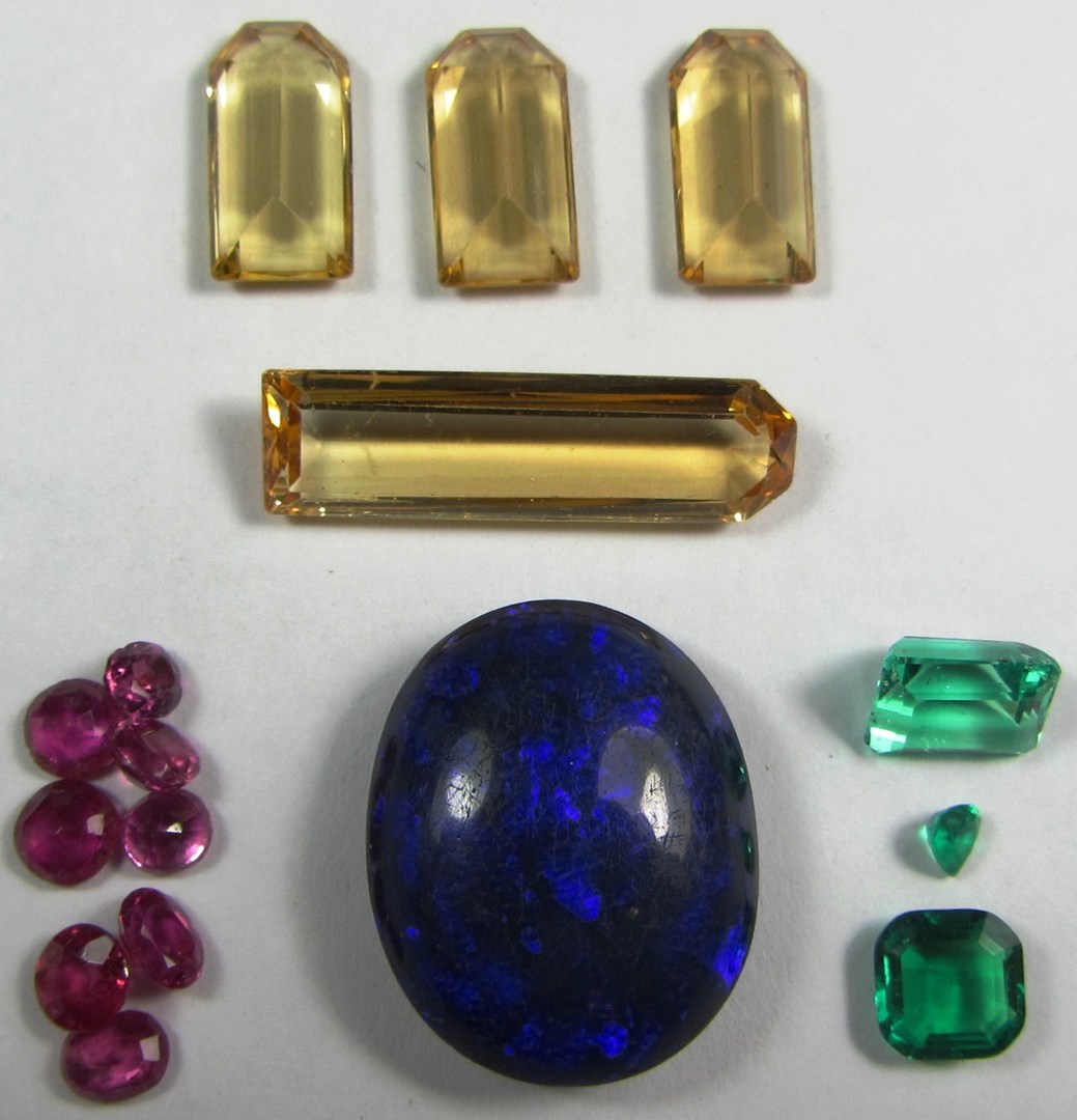 Appraisal: A collection of unmounted gemstones comprising emeralds topaz rubies and