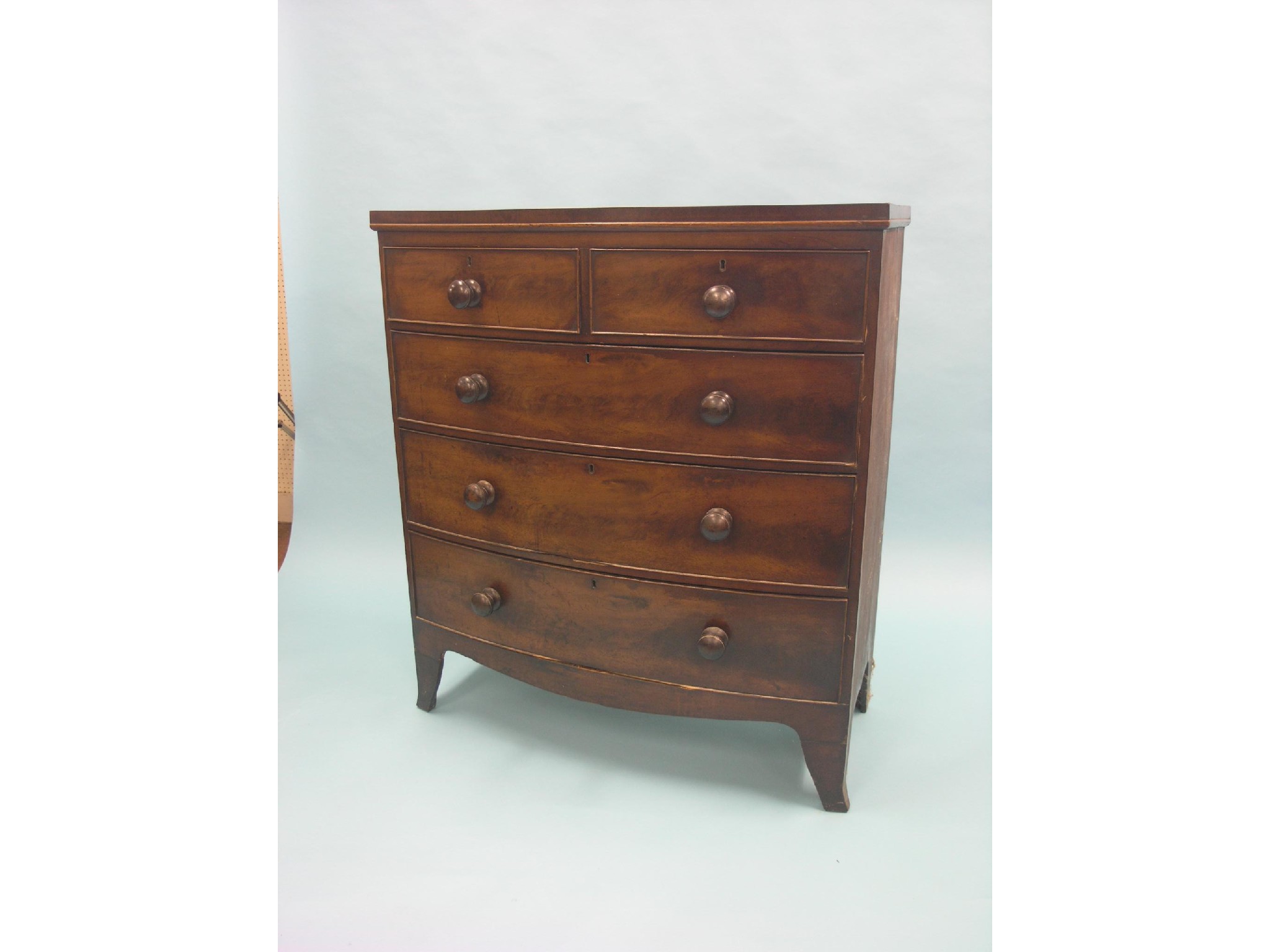 Appraisal: A Victorian bow-fronted mahogany chest two short and three long