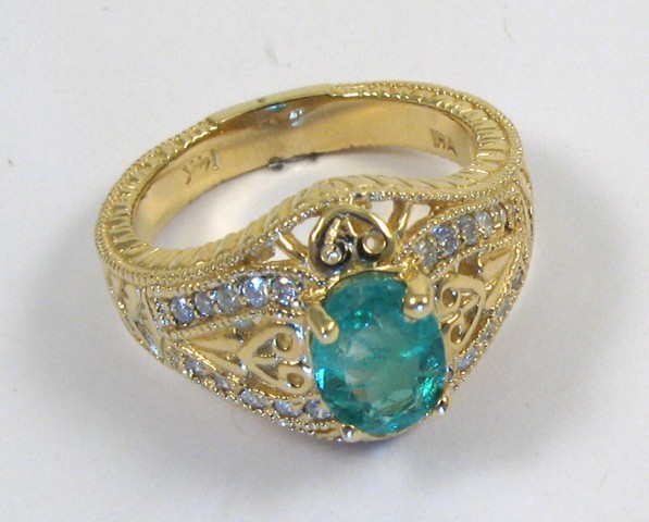 Appraisal: EMERALD DIAMOND AND YELLOW GOLD RING The k gold band