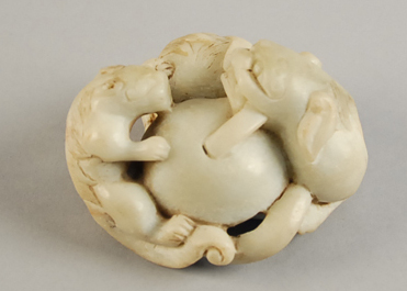 Appraisal: A Carved Jade Foo Dog Group in a celadon green